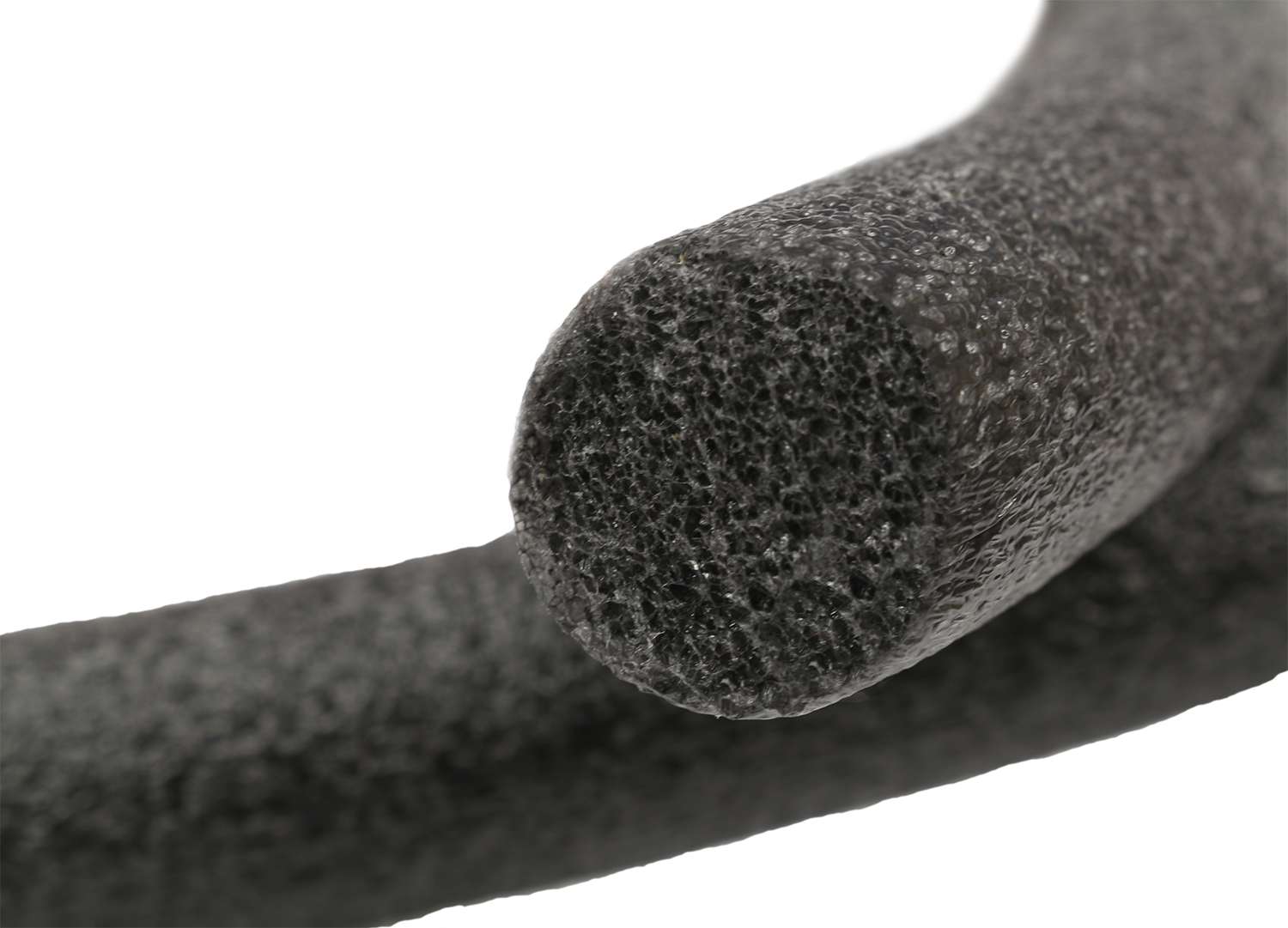 Close-up of a black foam pipe insulation roll on a white background