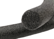 Close-up of a black foam pipe insulation roll on a white background
