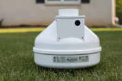 A white round radon fan with the brand name GX4 Pro Series Radon Fan visible on it, designed for indoor and outdoor use.
